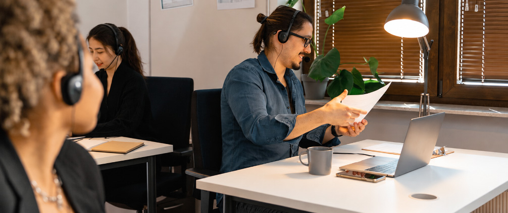 Two phone proposals reviewed against the same business requirements checklist.